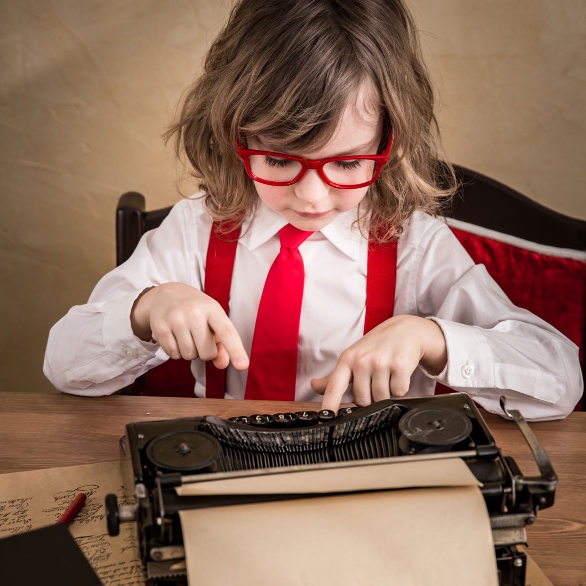 Child businessman typing on a typewriter